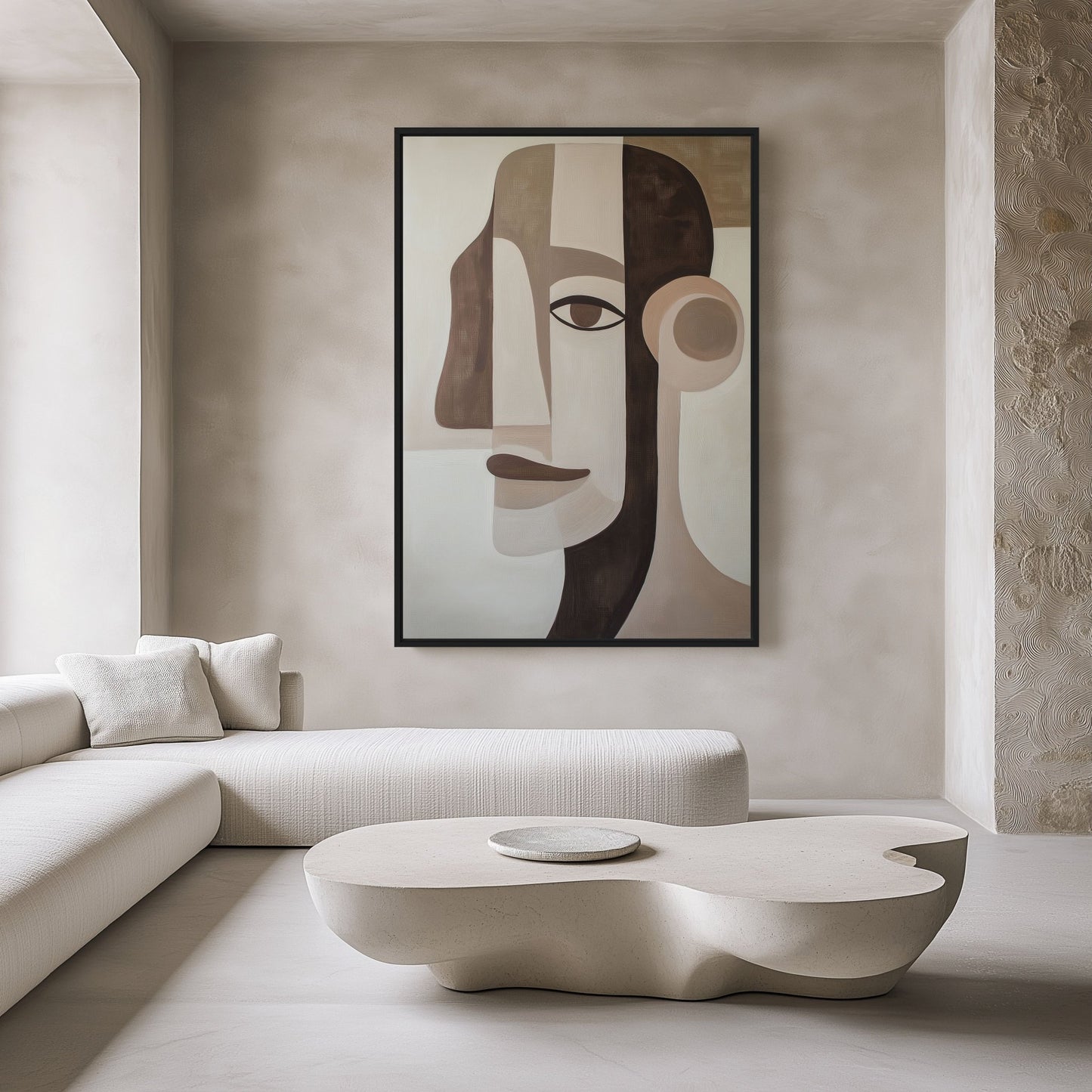 Beige, brown and black cubist male portrait above a white sectional and sculptural coffee table