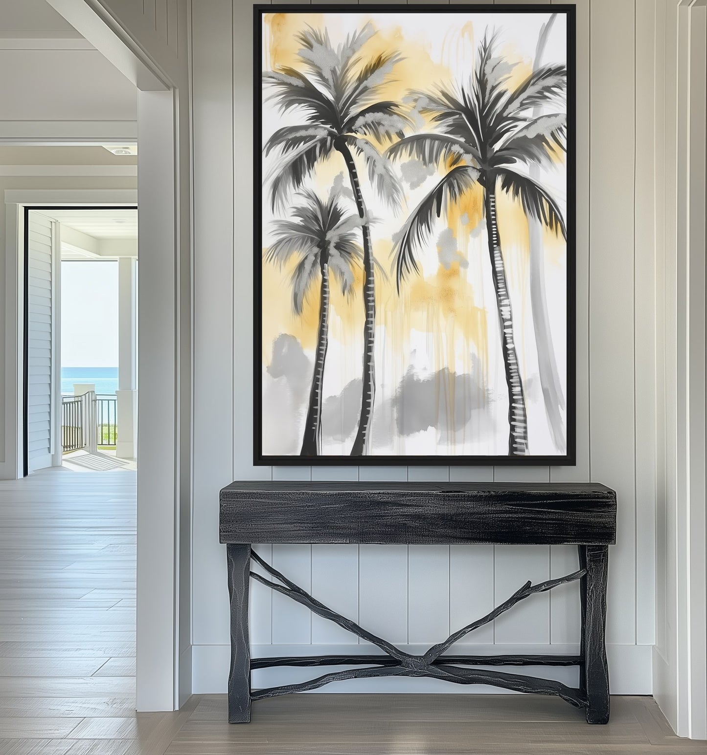 Black, gray and yellow palm tree artwork above a black branch-frame console on a white paneled wall