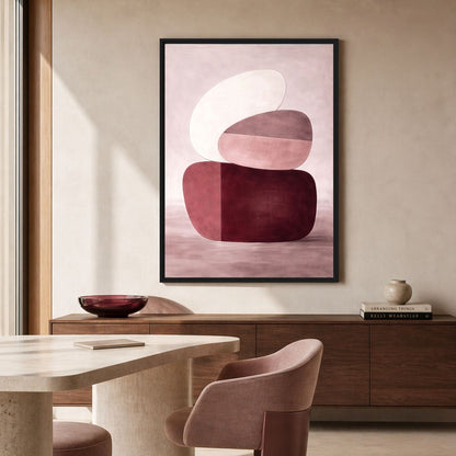 Burgundy and blush geometric Framed Canvas above a wood sideboard beside a round dining table