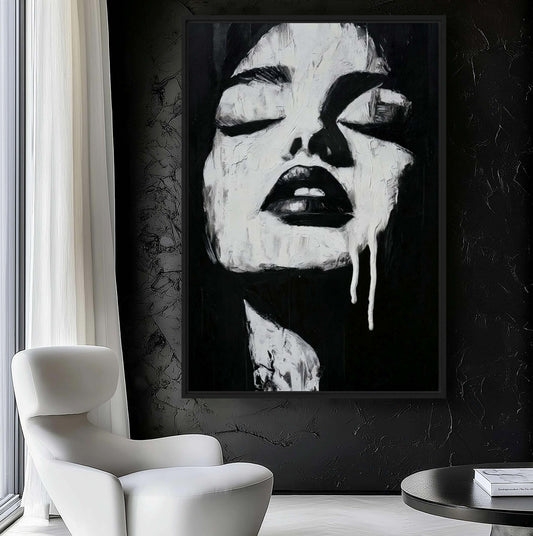 Monochrome woman portrait beside a white lounge chair against a dark textured wall