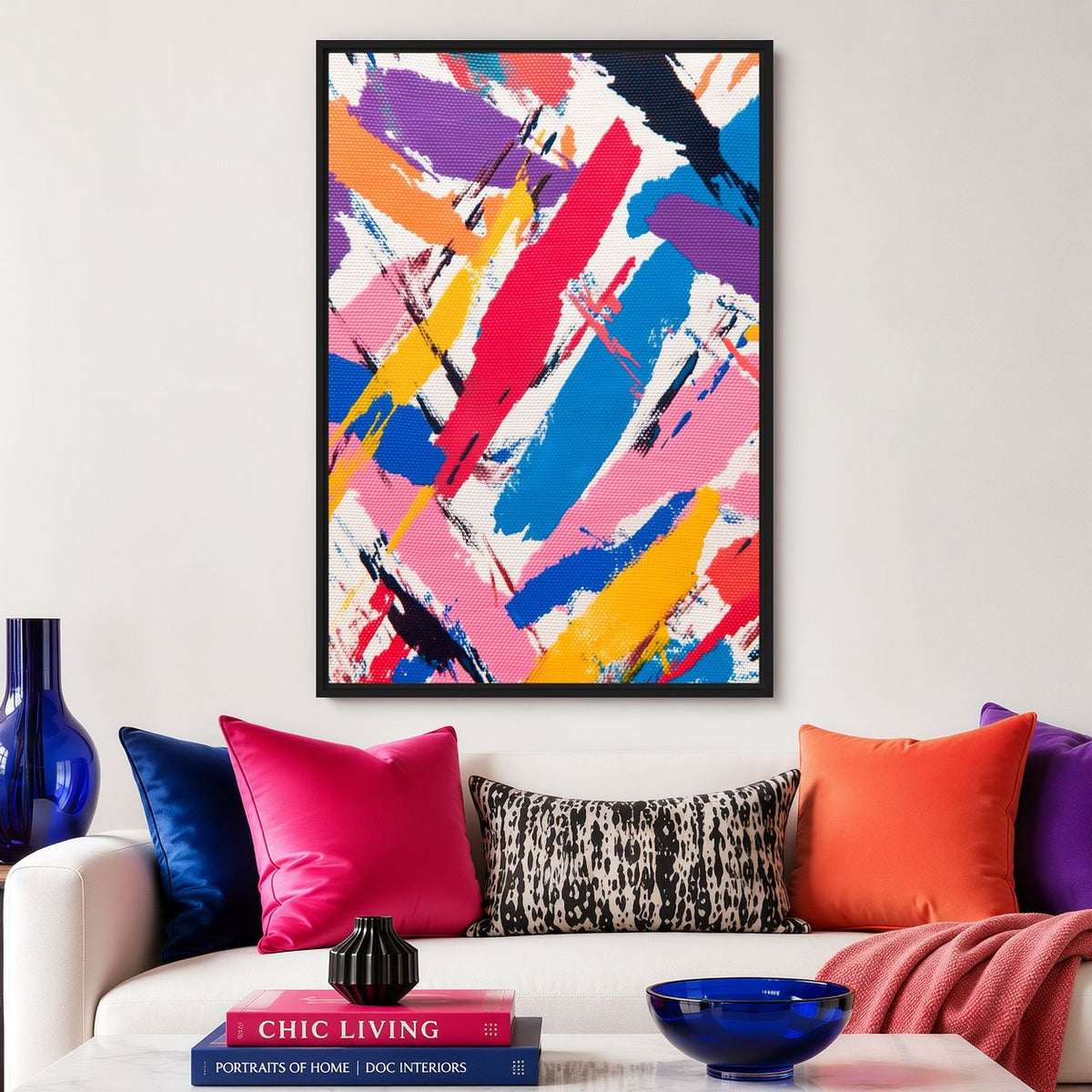Colourful brushstroke canvas above a sofa with bright pink and orange cushions
