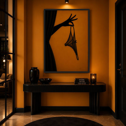 Black and amber lingerie canvas above a dark console on an orange wall
