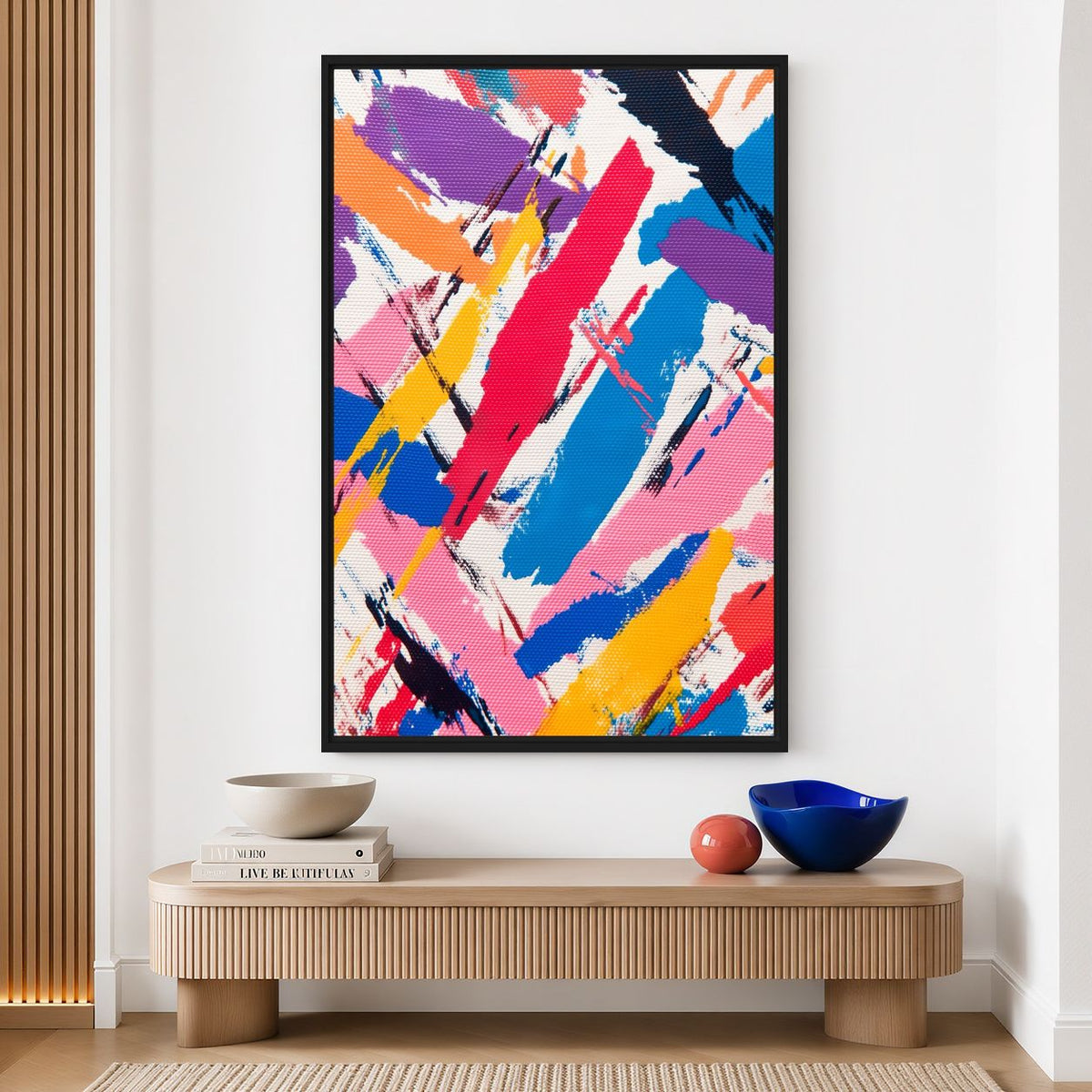 Multicoloured abstract canvas above a pale wooden console