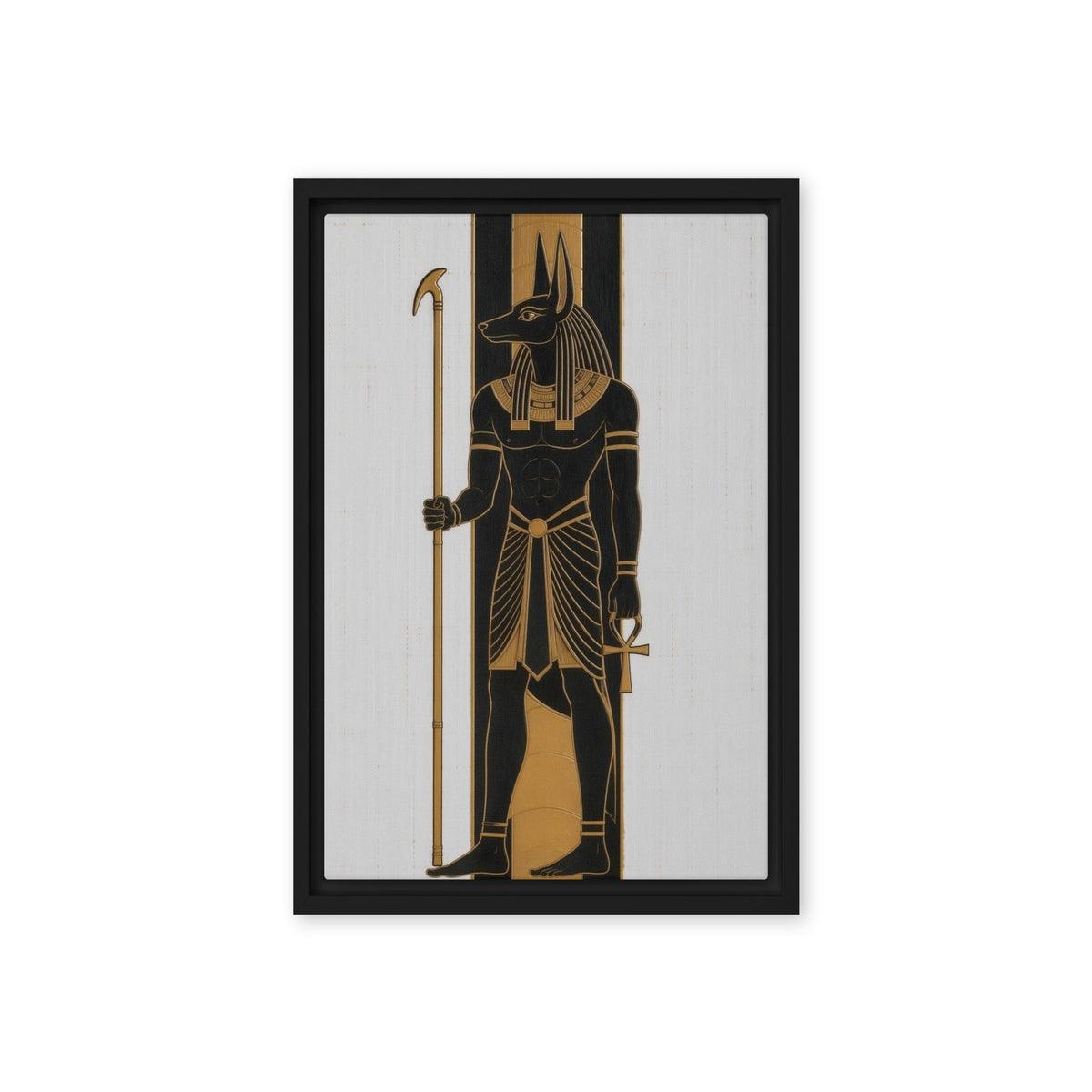 Black and gold Anubis figure holding a staff against pale vertical panels, front view with black frame, 12″×18″ nominal canvas