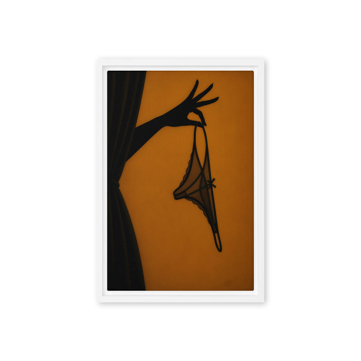 A black silhouette of a hand holds delicate lingerie against an amber-orange background; front view in a white frame, 12 x 18 in canvas